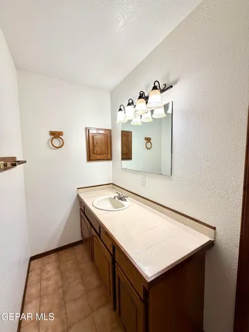 a bathroom with a shower and a sink