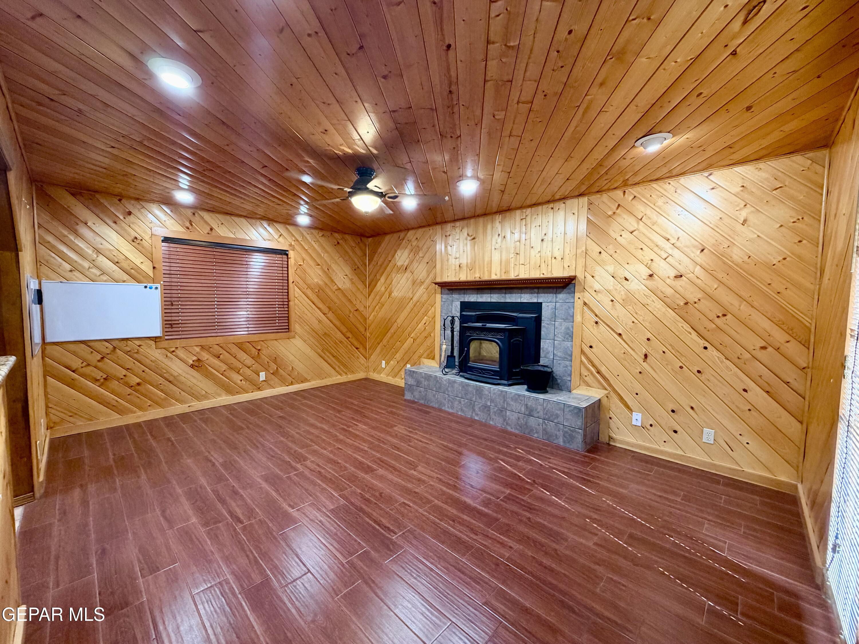 2452 West Ohara Road Anthony, NM 88021 - Photo 27 of 56 a view of empty room with wooden floor and fireplace