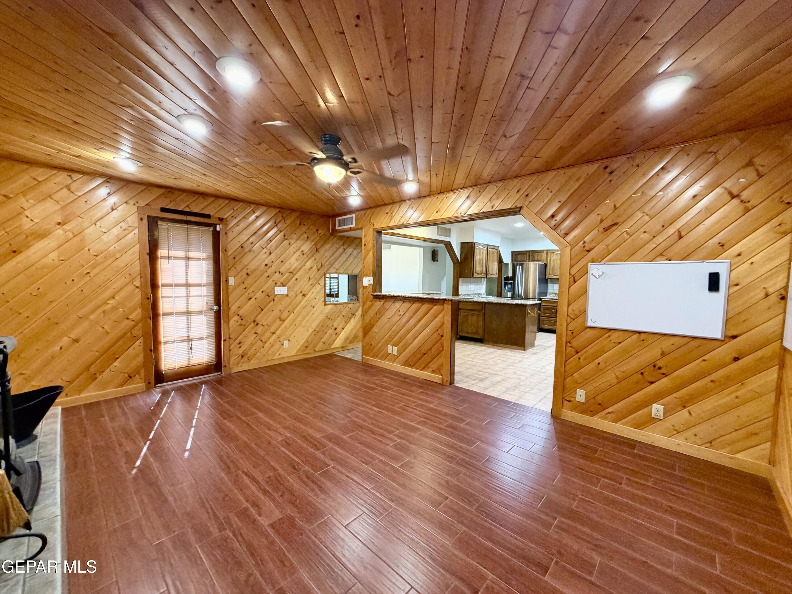 2452 West Ohara Road Anthony, NM 88021 - Photo 29 of 56 a view of an empty room with wooden floor and a window