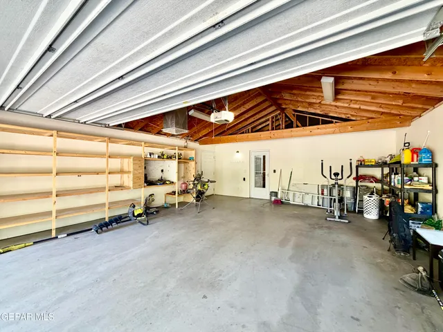 a kitchen with a refrigerator and a stove top oven