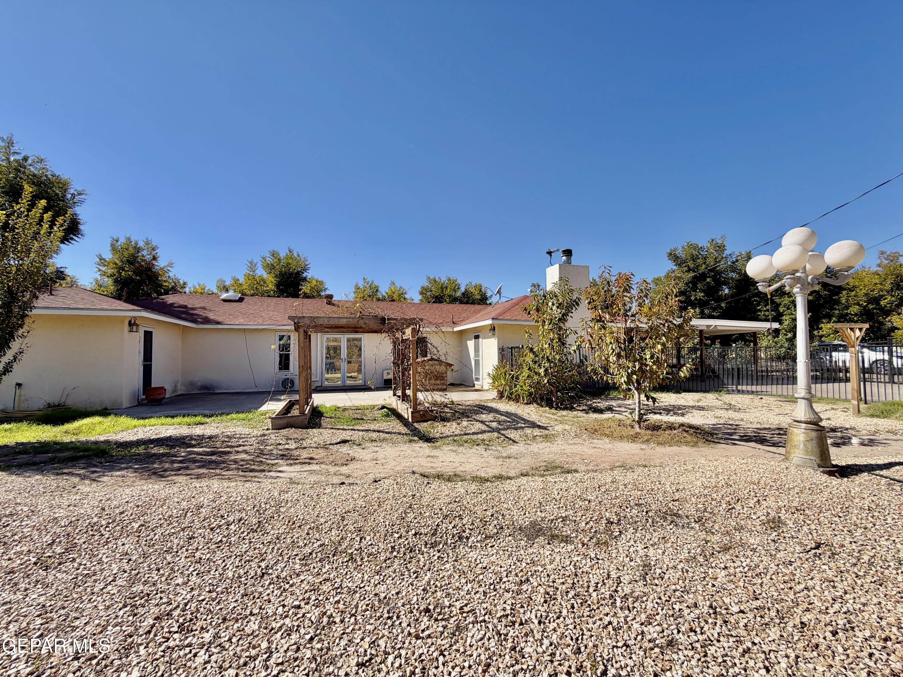 2452 West Ohara Road Anthony, NM 88021 - Photo 45 of 56 a view of a backyard with a table and chairs