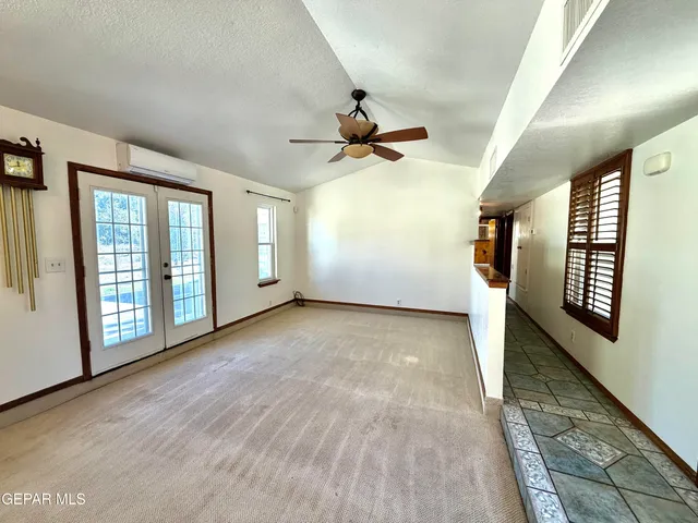 a view of a livingroom with a ceiling fan and window