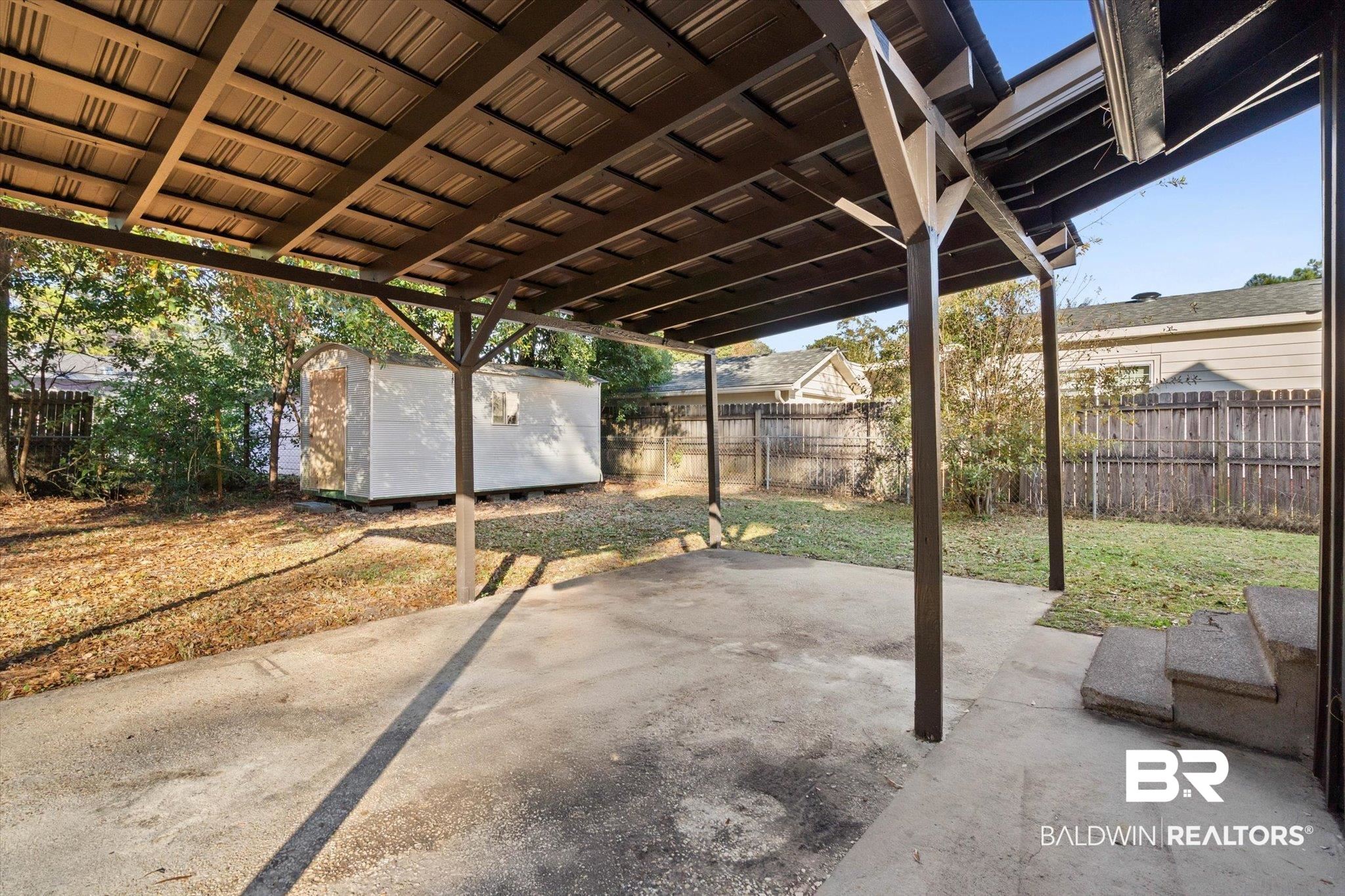 2806 Exter Drive Mobile, AL 36606 - Photo 17 of 24 Fenced backyard with a storage shed and a patio