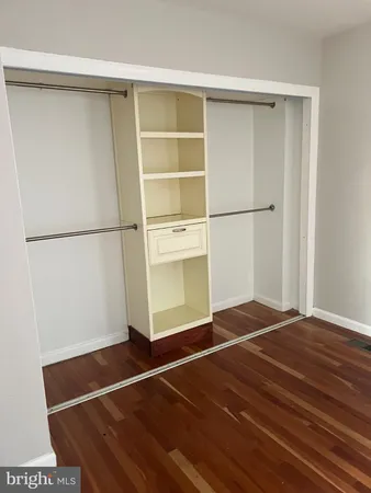 a room with a bed and a refrigerator