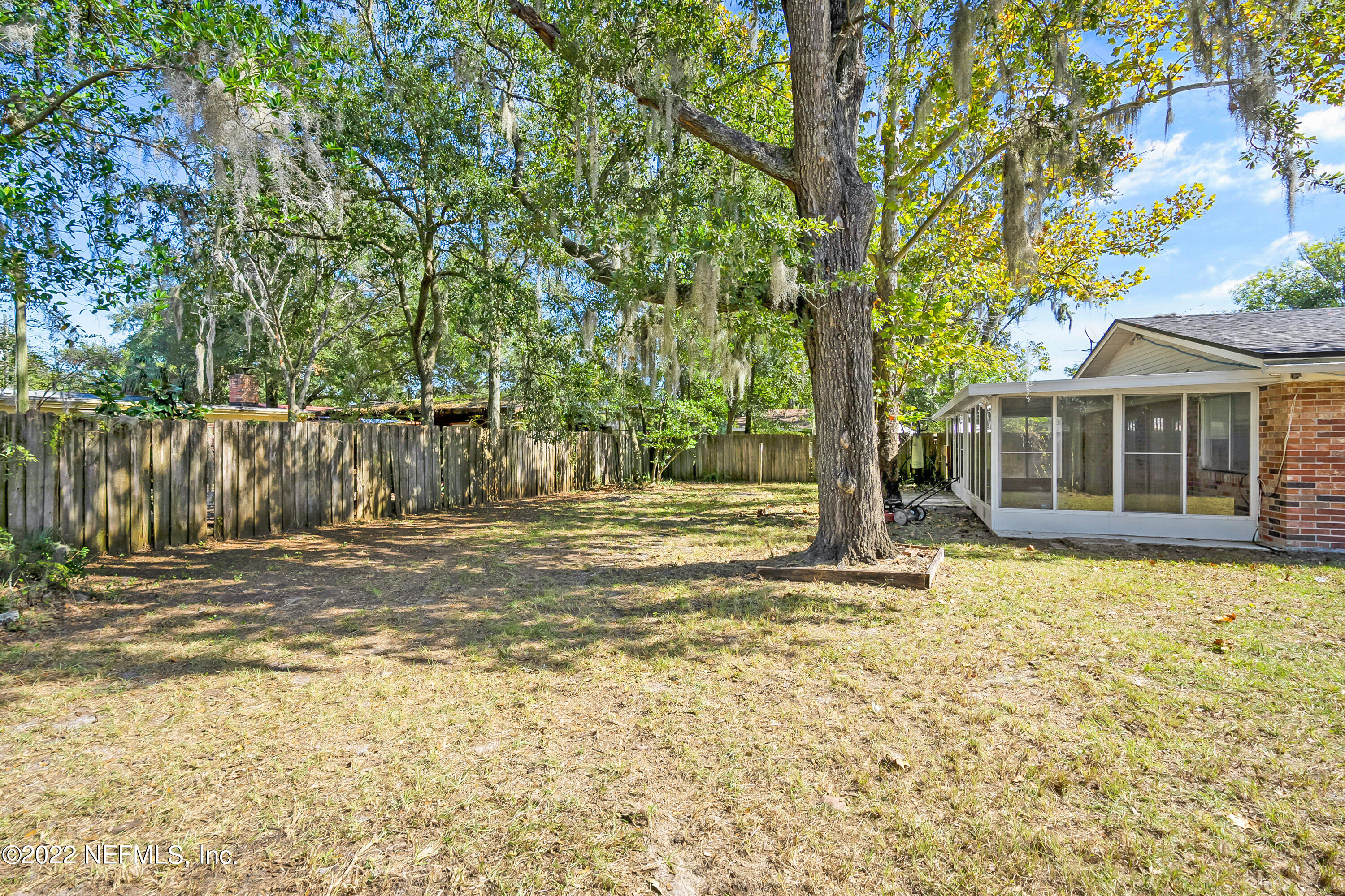 7539 Wheat Road Jacksonville, FL 32244 - Photo 29 of 32 a view of a house with backyard and tree