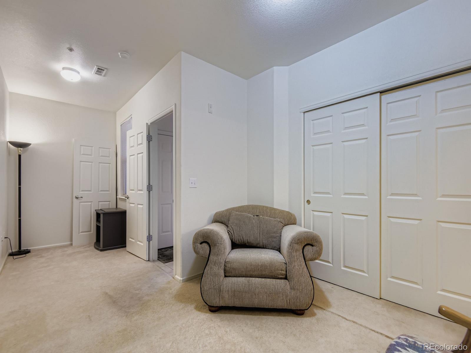 5255 Memphis Street, Unit 307 Denver, CO 80239 - Photo 12 of 29 a living room with furniture a walk in closet