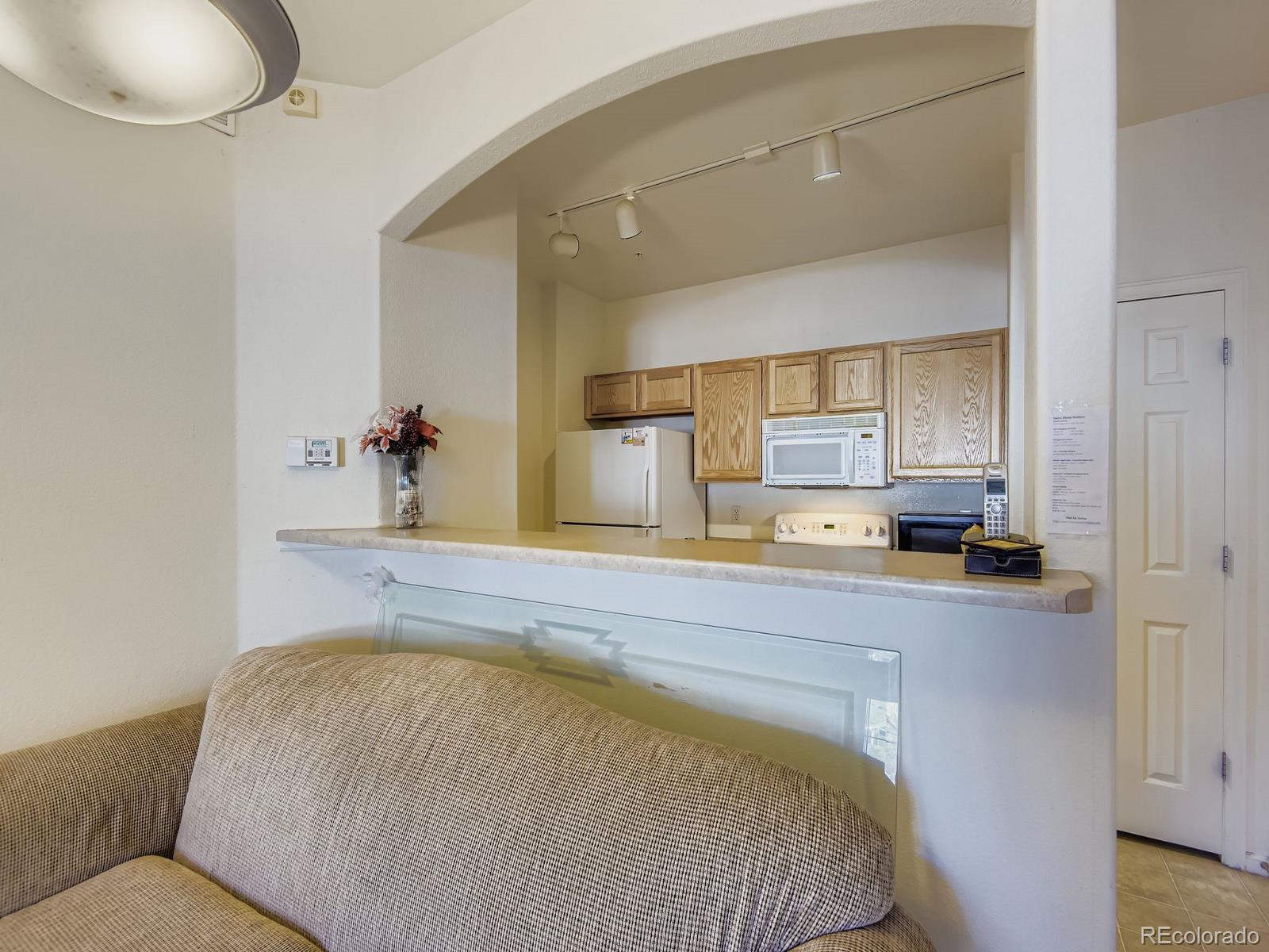 5255 Memphis Street, Unit 307 Denver, CO 80239 - Photo 15 of 29 a bed room with a bed and mirror