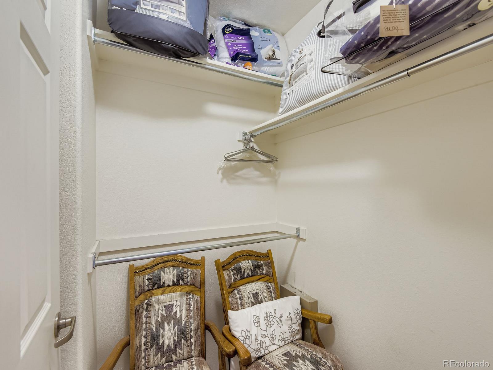 5255 Memphis Street, Unit 307 Denver, CO 80239 - Photo 16 of 29 a view of walk in closet with clothes and shoes
