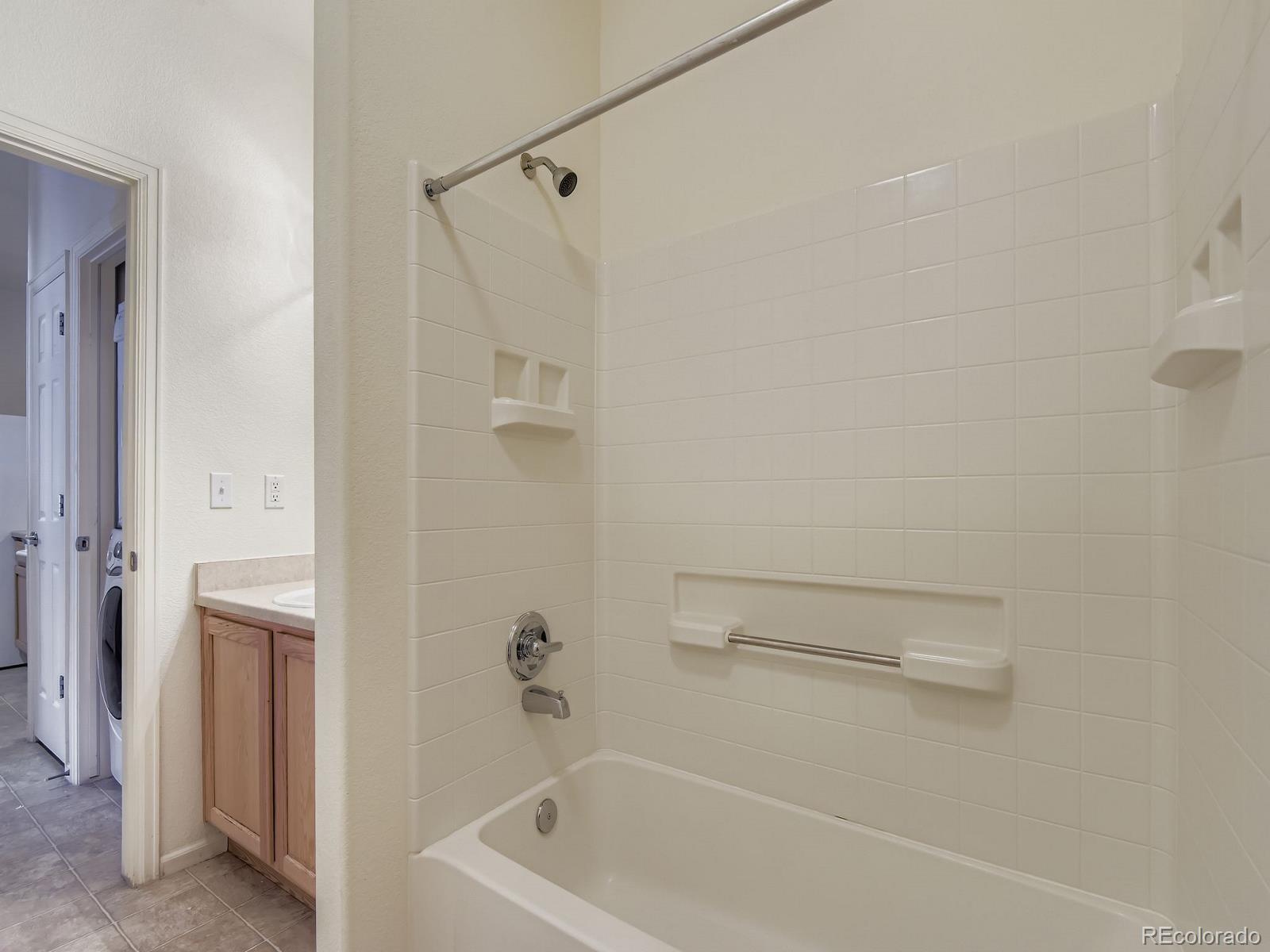 5255 Memphis Street, Unit 307 Denver, CO 80239 - Photo 17 of 29 a bathroom with a bathtub