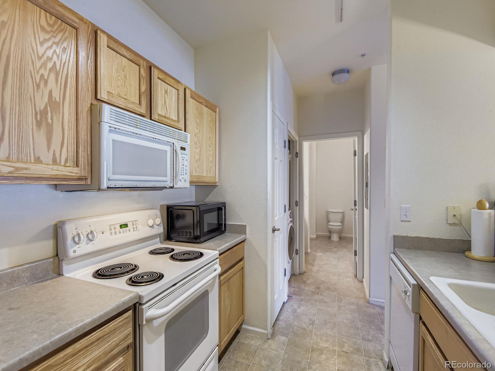 5255 Memphis Street, Unit 307 Denver, CO 80239 - Photo 21 of 29 a kitchen with a stove and a sink