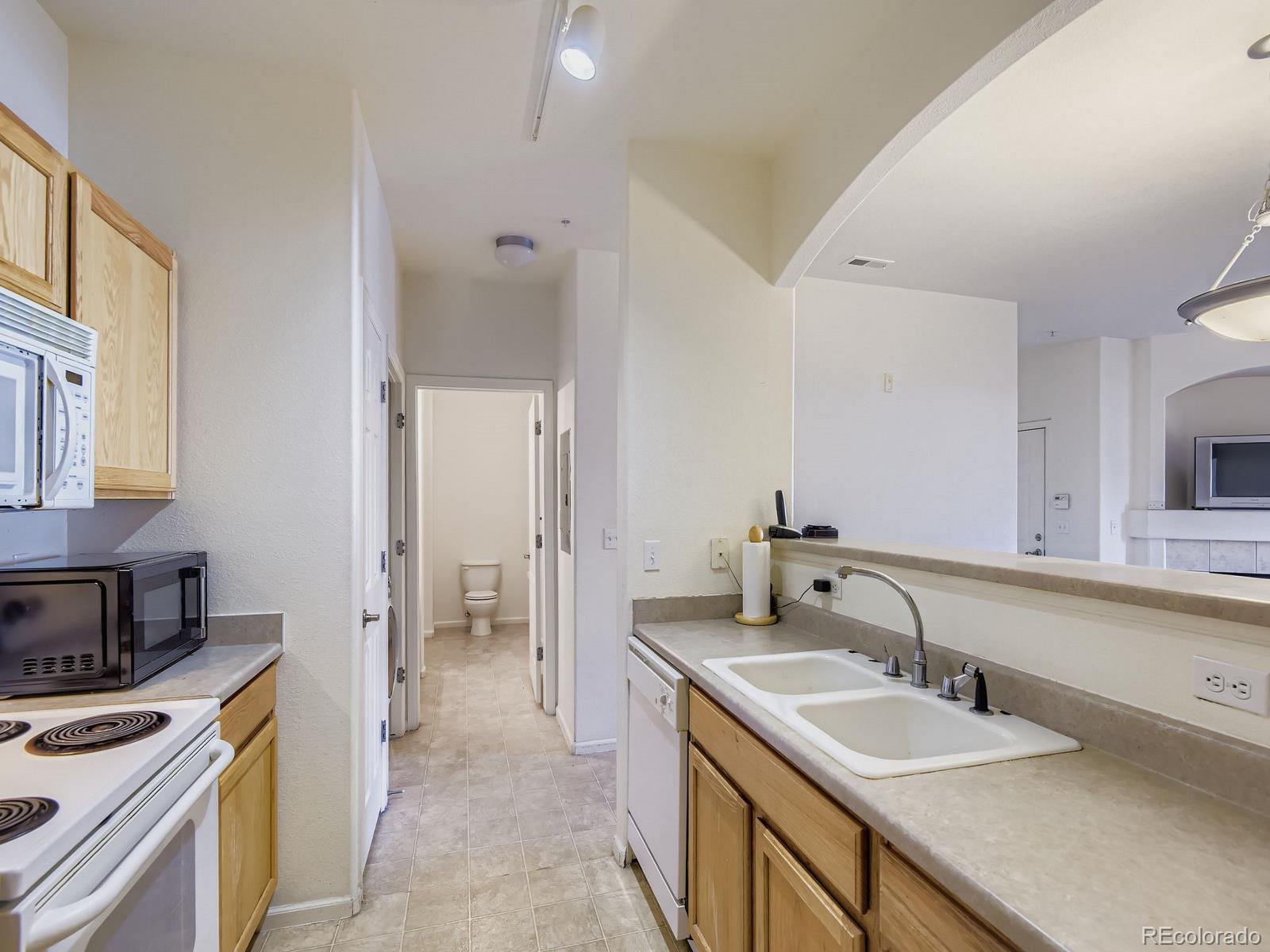5255 Memphis Street, Unit 307 Denver, CO 80239 - Photo 22 of 29 a bathroom with a sink and a mirror
