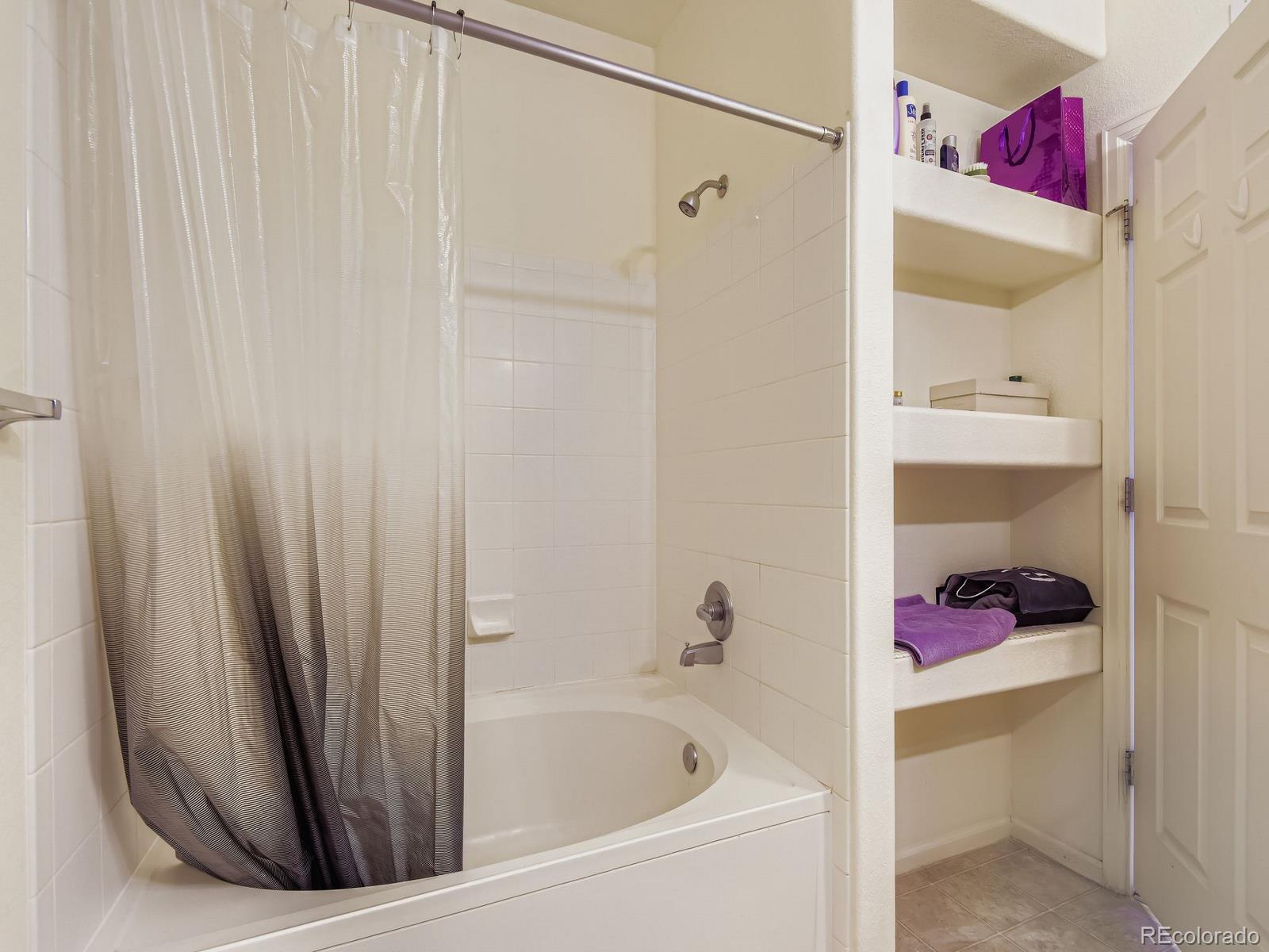 5255 Memphis Street, Unit 307 Denver, CO 80239 - Photo 24 of 29 a bathroom with a bathtub and a shower