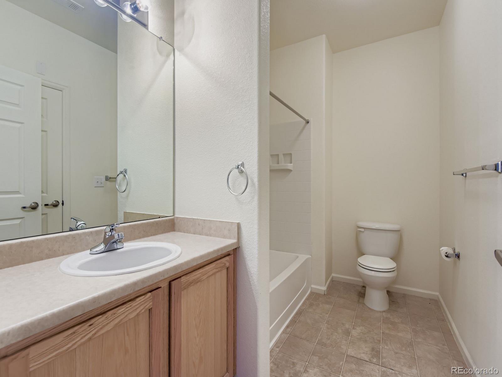 5255 Memphis Street, Unit 307 Denver, CO 80239 - Photo 25 of 29 a bathroom with a sink a toilet and shower