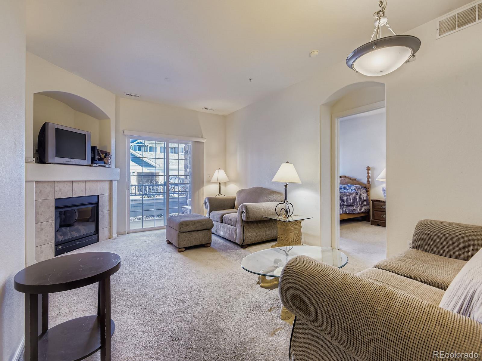 5255 Memphis Street, Unit 307 Denver, CO 80239 - Photo 26 of 29 a living room with furniture and a fireplace