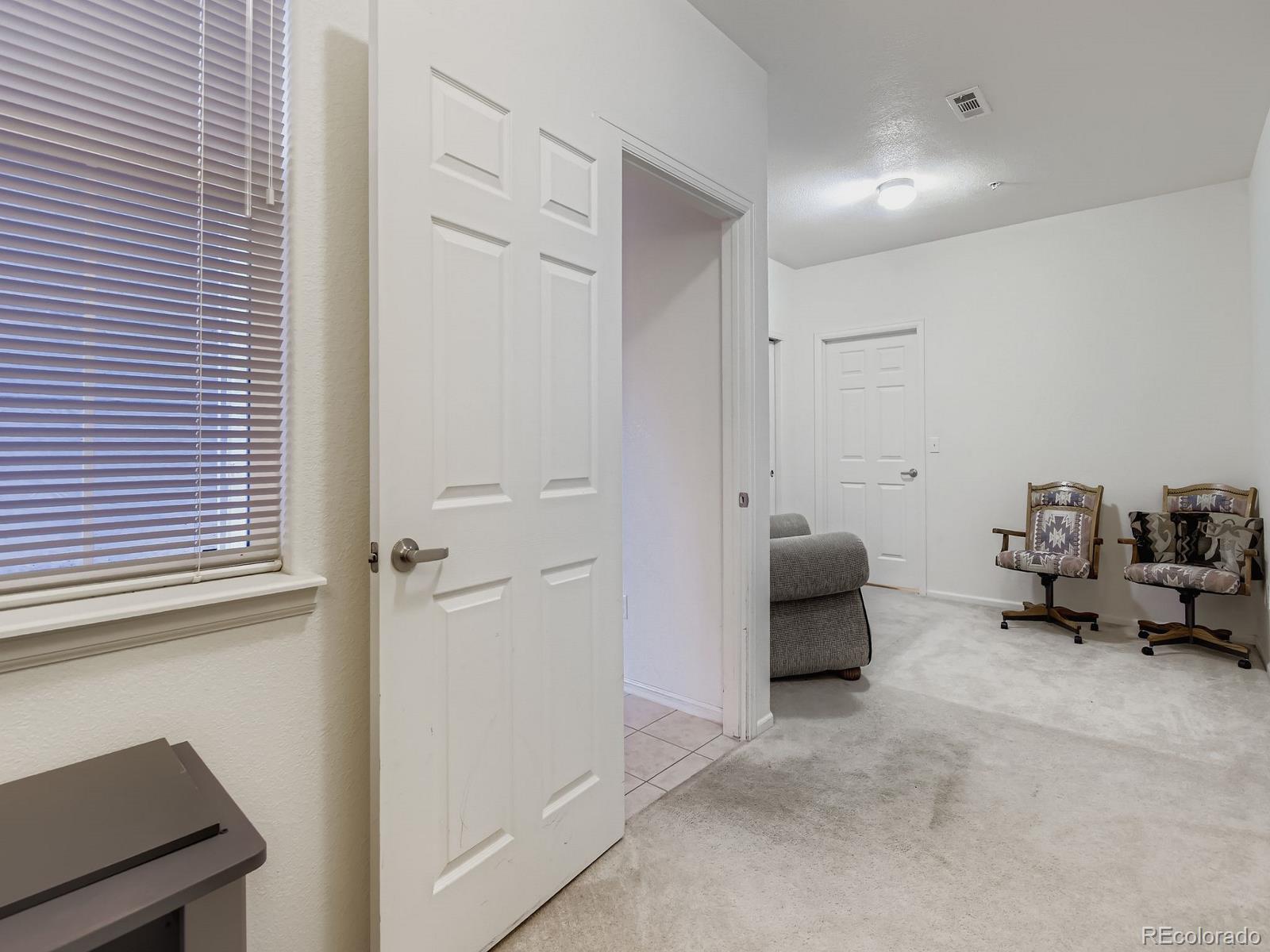 5255 Memphis Street, Unit 307 Denver, CO 80239 - Photo 3 of 29 a bedroom with furniture and a window