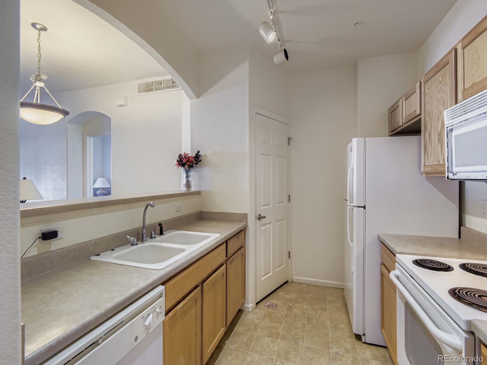 5255 Memphis Street, Unit 307 Denver, CO 80239 - Photo 7 of 29 a bathroom with a sink and a mirror