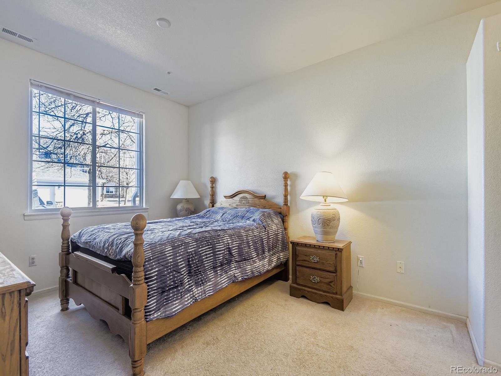 5255 Memphis Street, Unit 307 Denver, CO 80239 - Photo 8 of 29 a bedroom with a bed and a window