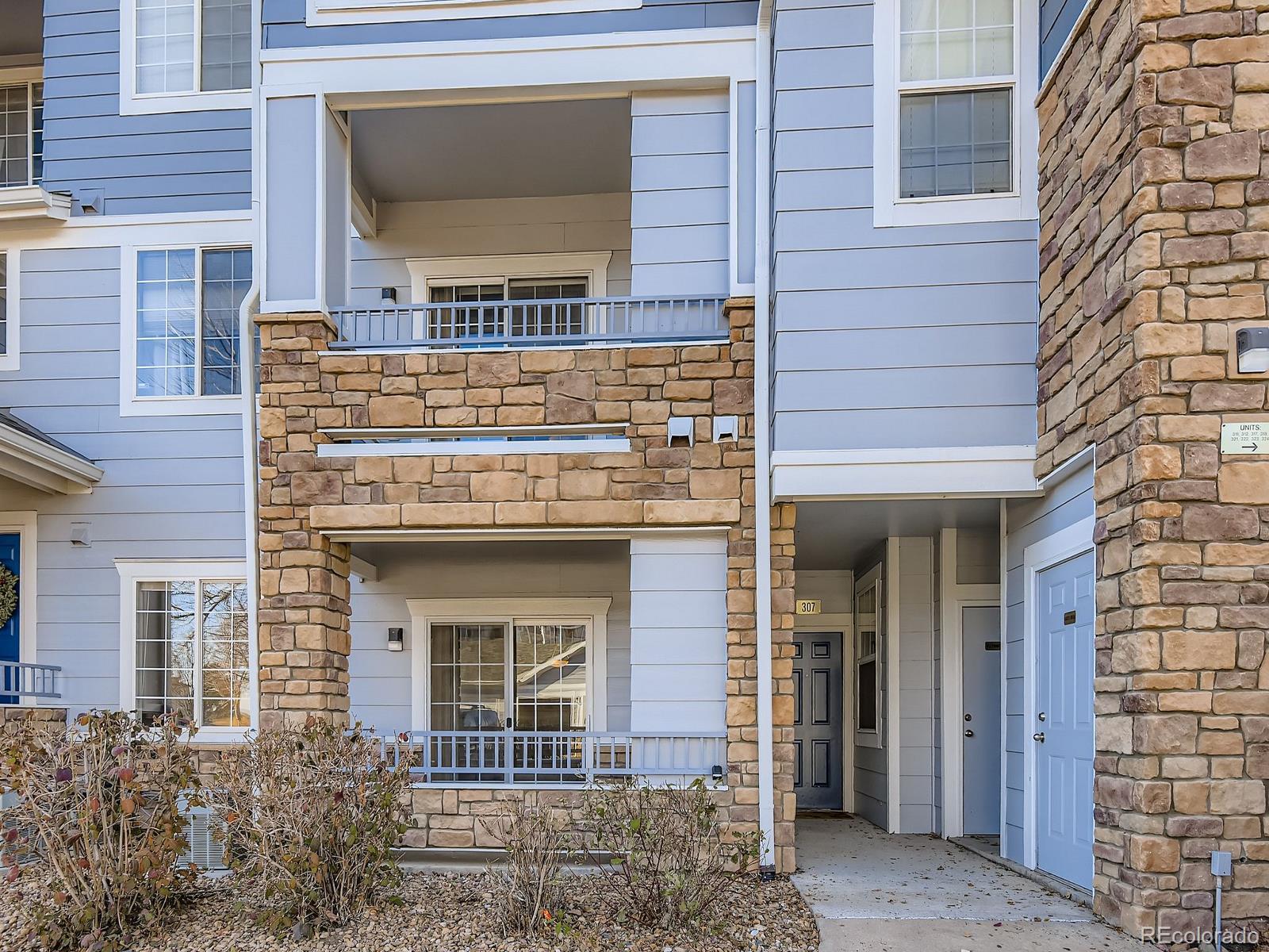 5255 Memphis Street, Unit 307 Denver, CO 80239 - Photo 10 of 29 a front view of a house with a garden