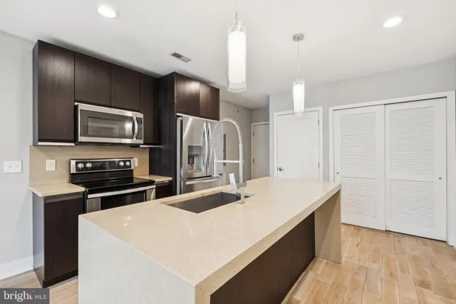 a large kitchen with a stove a sink and a refrigerator