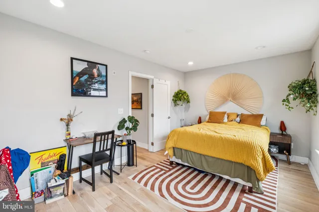 a bedroom with a bed and a painting on the wall