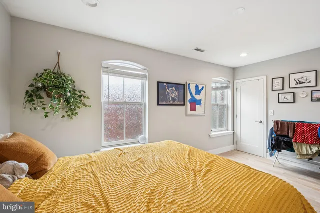 a bedroom with a bed and a couch