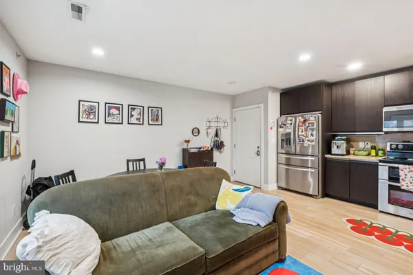 a living room with furniture and kitchen view