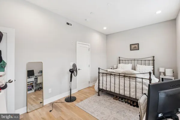 a bedroom with a bed and a dresser