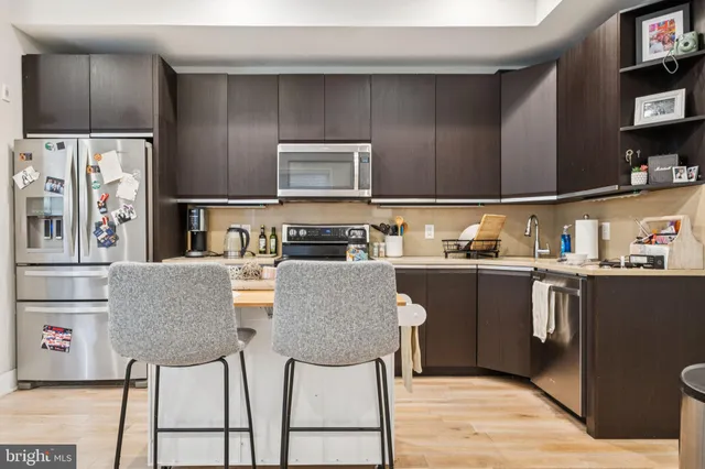 a kitchen with stainless steel appliances granite countertop a refrigerator and microwave