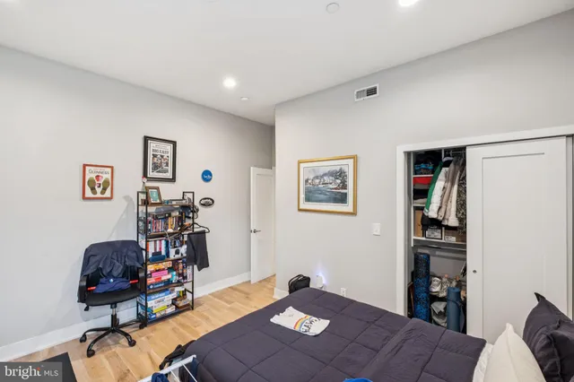 a bedroom with furniture and a wooden floor