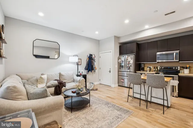 a living room with furniture and a wooden floor