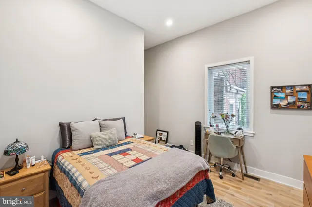 a bedroom with a bed a table and chair