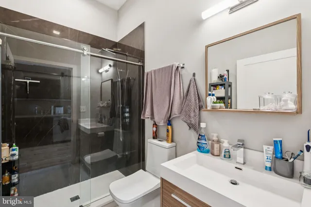 a bathroom with a sink toilet and shower