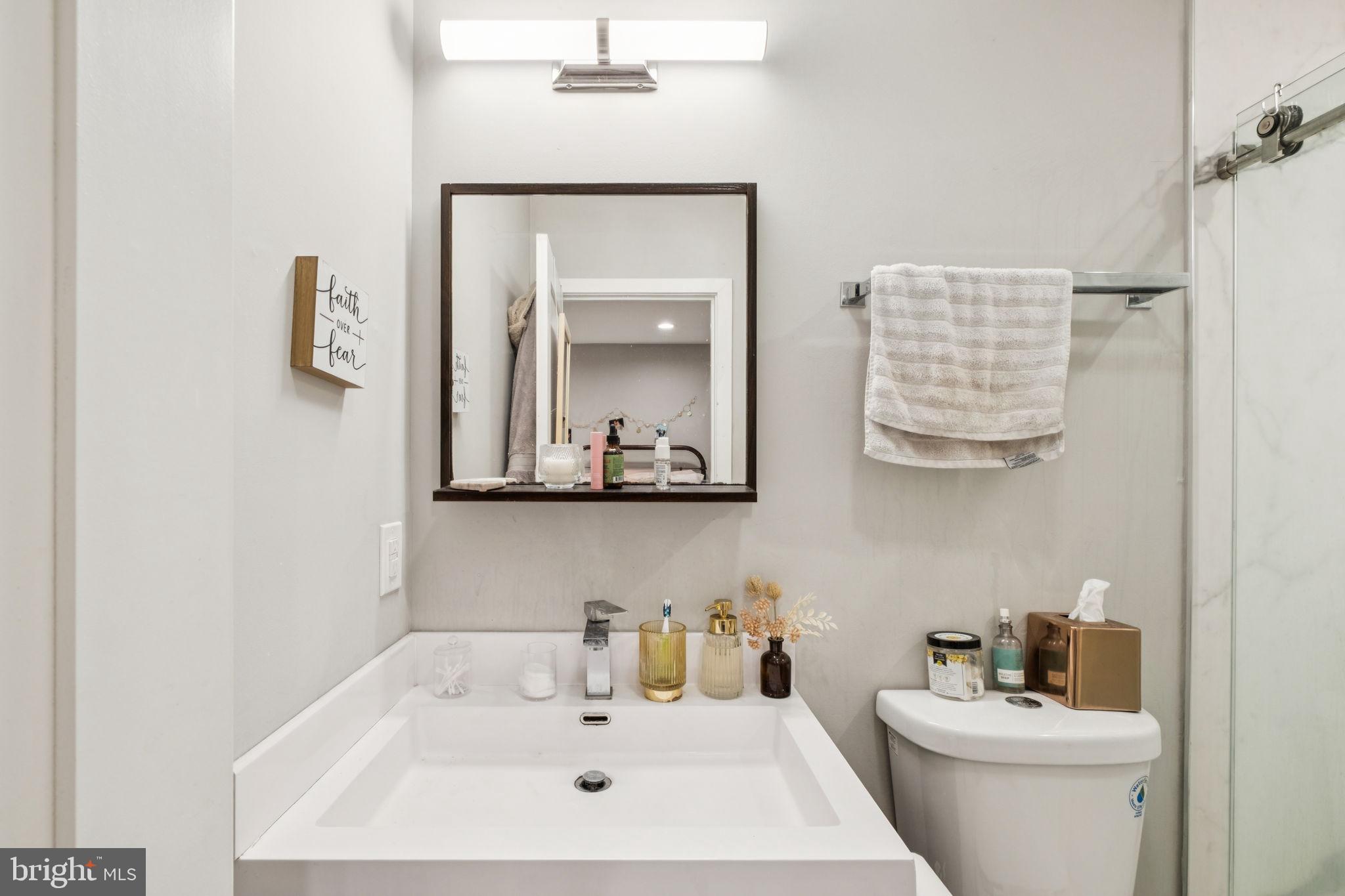 1516 Green Street Philadelphia, PA 19130 - Photo 30 of 36 a bathroom with a sink a toilet and mirror