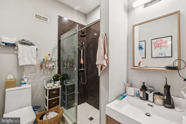 a bathroom with a sink toilet and shower