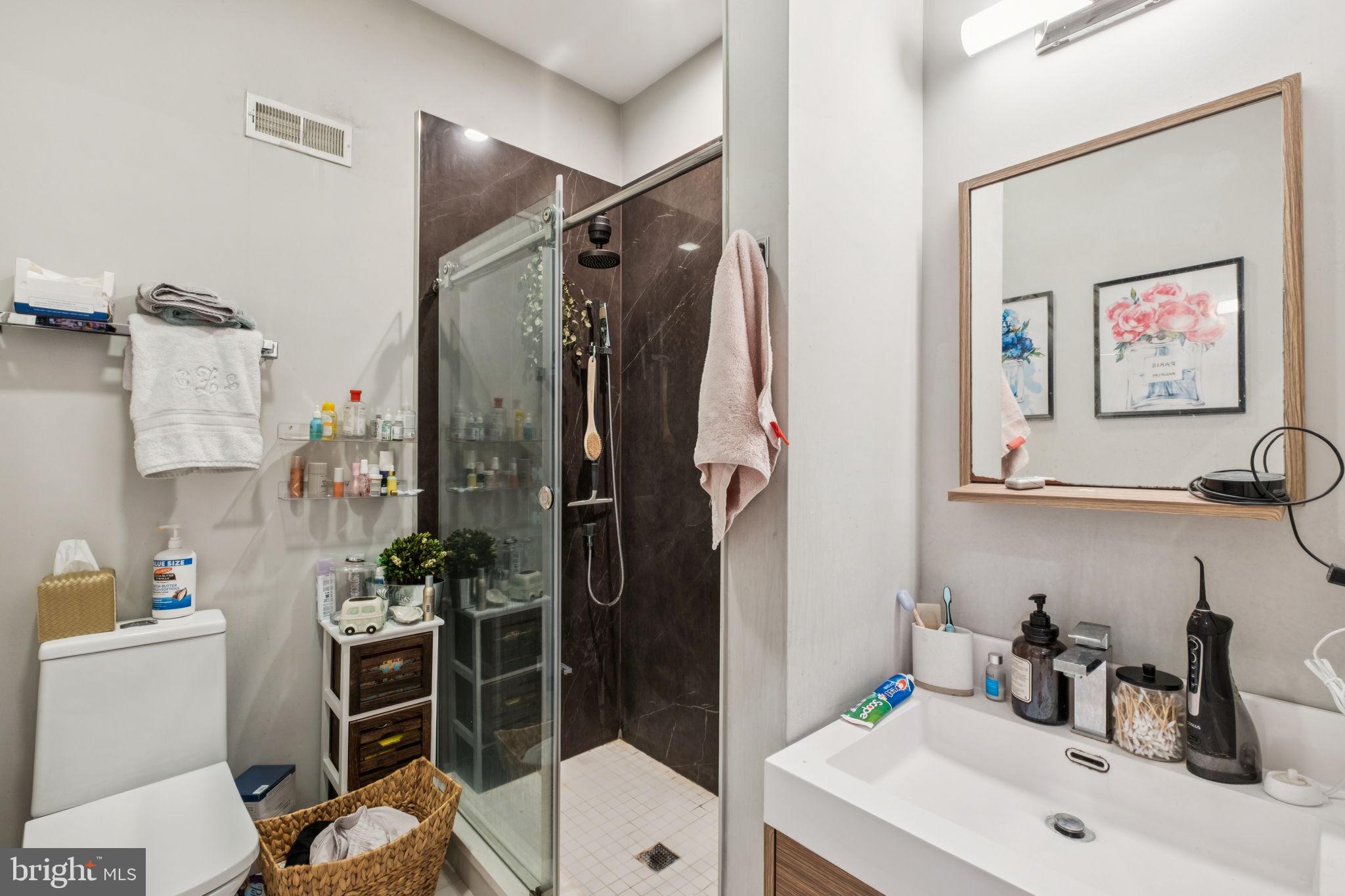 1516 Green Street Philadelphia, PA 19130 - Photo 33 of 36 a bathroom with a sink toilet and shower