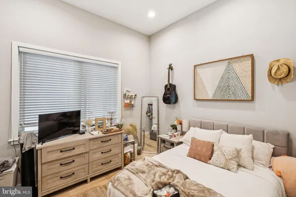 a bedroom with a bed and a television
