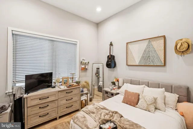 a bedroom with a bed and a television