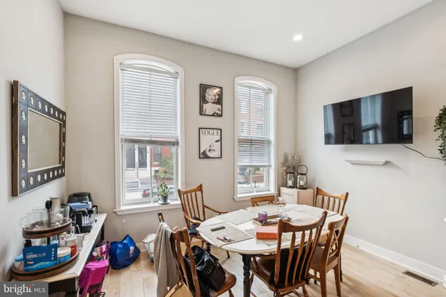 a view of a dining room with furniture and a flat screen tv