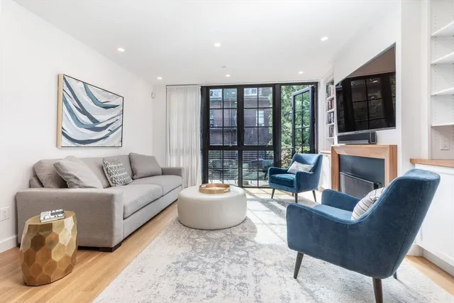 a living room with fireplace furniture and a flat screen tv