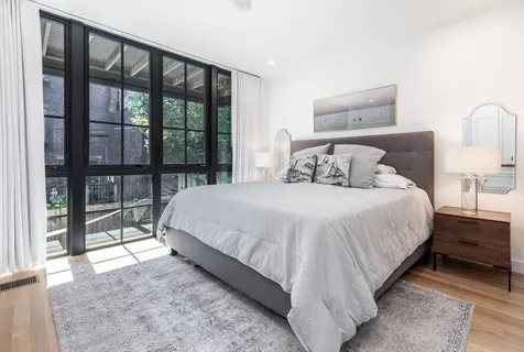 a bedroom with a large bed and a large window