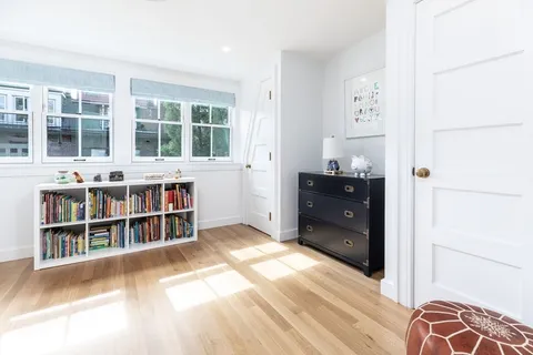 a view of a bedroom with furniture and window