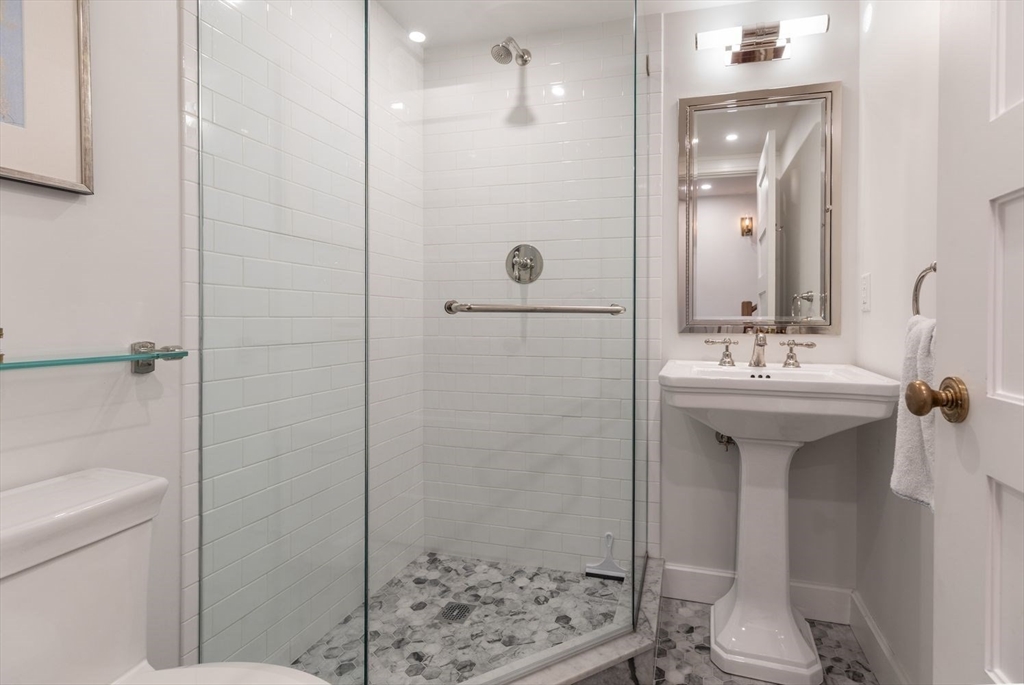 27 Lawrence Street Boston, MA 02116 - Photo 27 of 38 a bathroom with a sink a toilet and shower