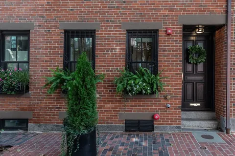 a couple of potted plants in front of door