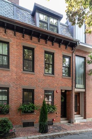 a front view of a building with plants