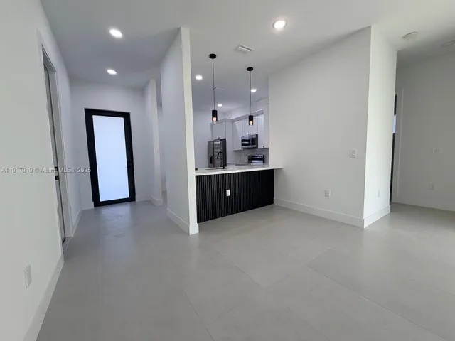 a view of a livingroom with a ceiling fan and window
