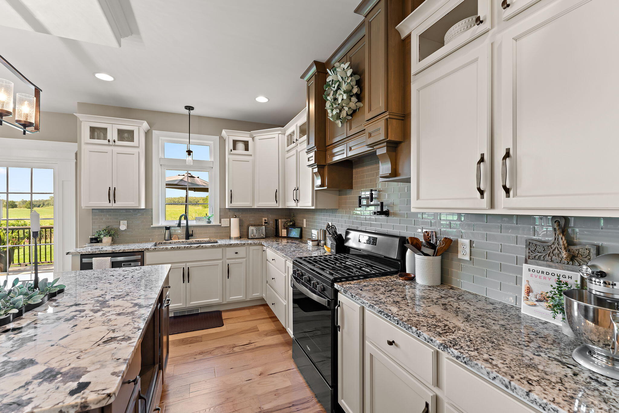 9192 Michigan Drive Crown Point, IN 46307 - Photo 23 of 66 a kitchen with a stove top oven sink and cabinets