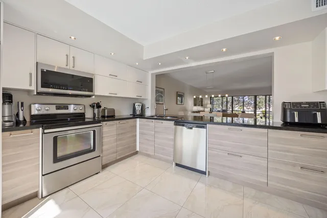 a kitchen with granite countertop cabinets and steel stainless steel appliances