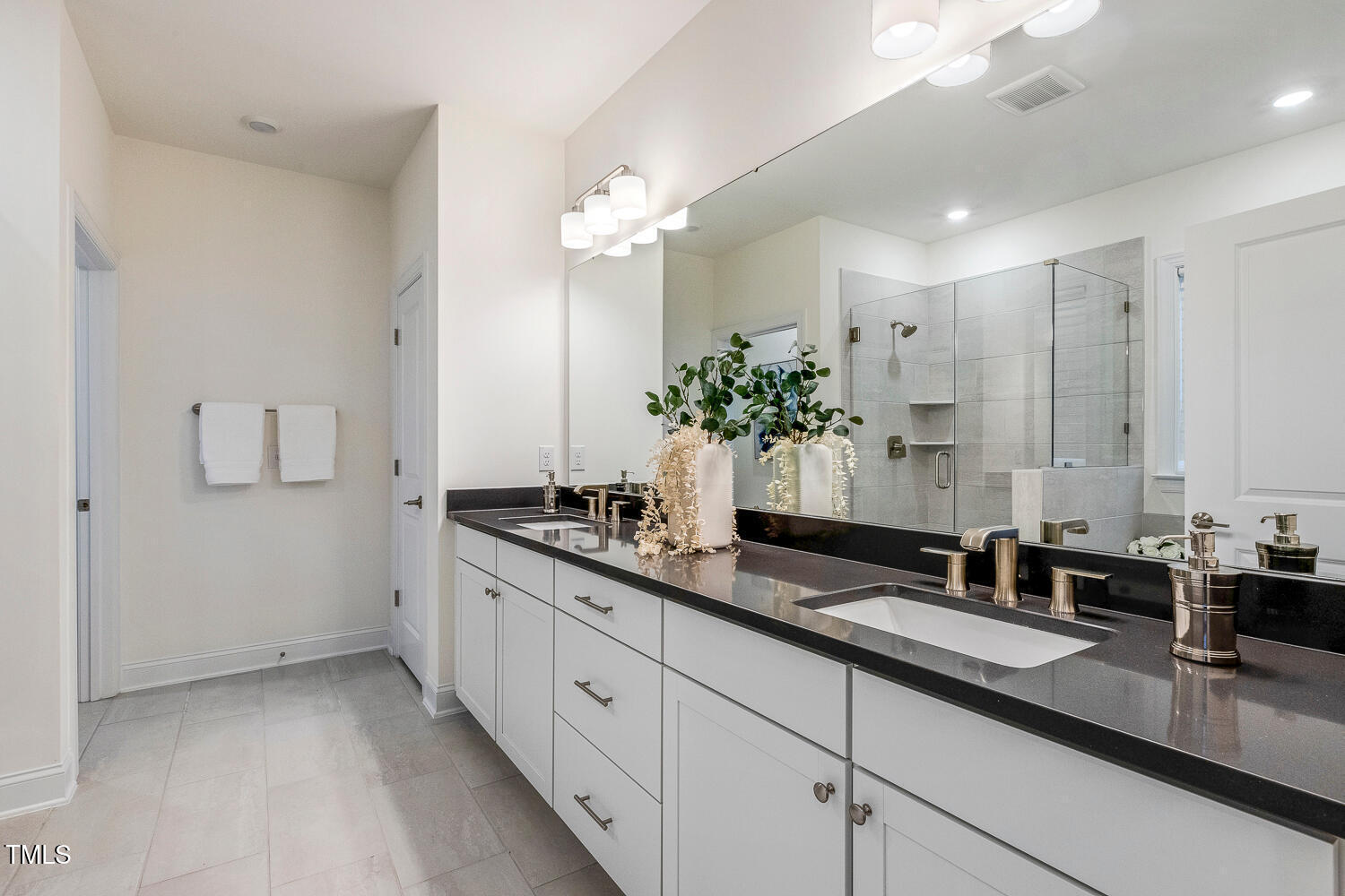 1116 Ciandra Barn Way Apex, NC 27523 - Photo 30 of 59 a bathroom with double sink and a mirror
