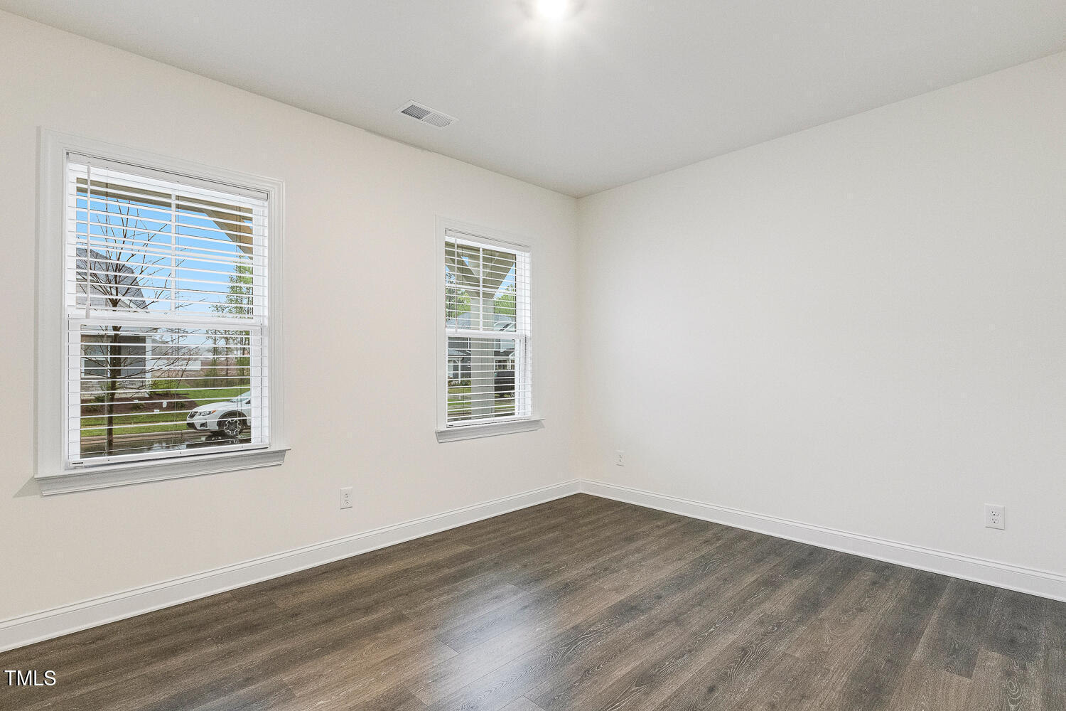 1116 Ciandra Barn Way Apex, NC 27523 - Photo 33 of 59 an empty room with wooden floor and windows