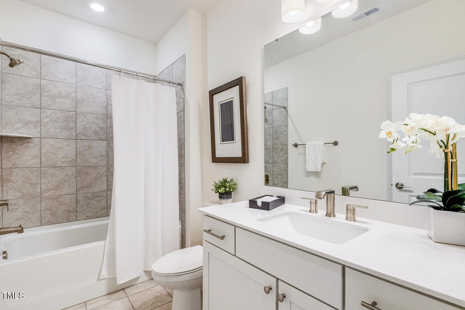 1116 Ciandra Barn Way Apex, NC 27523 - Photo 34 of 59 a bathroom with a sink a toilet and a large mirror